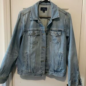 Lucky Brand women’s jean jacket with cross stitch on the back.